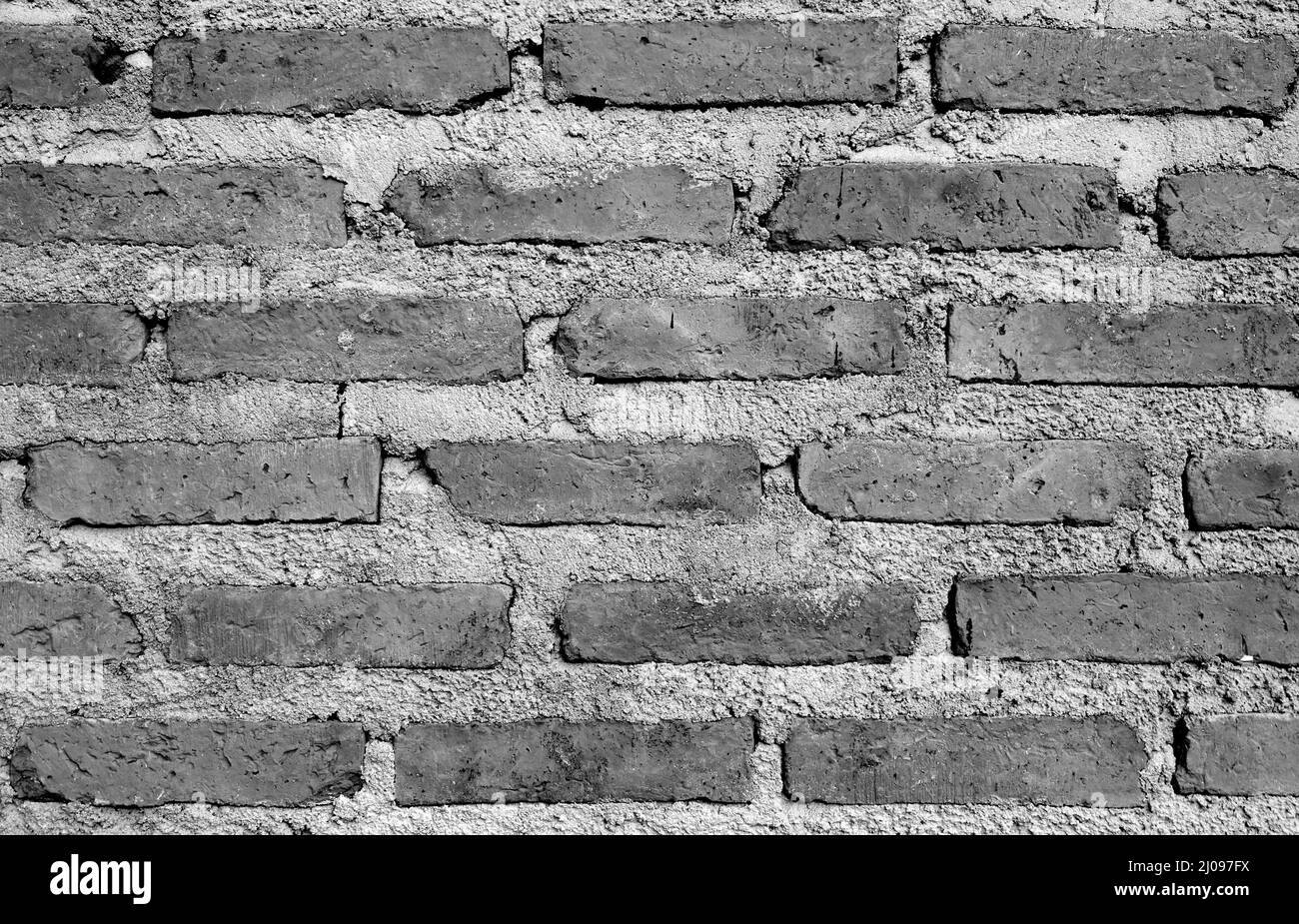 Vista frontale del muro di mattoni in grunge monocromatico per sfondo astratto Foto Stock