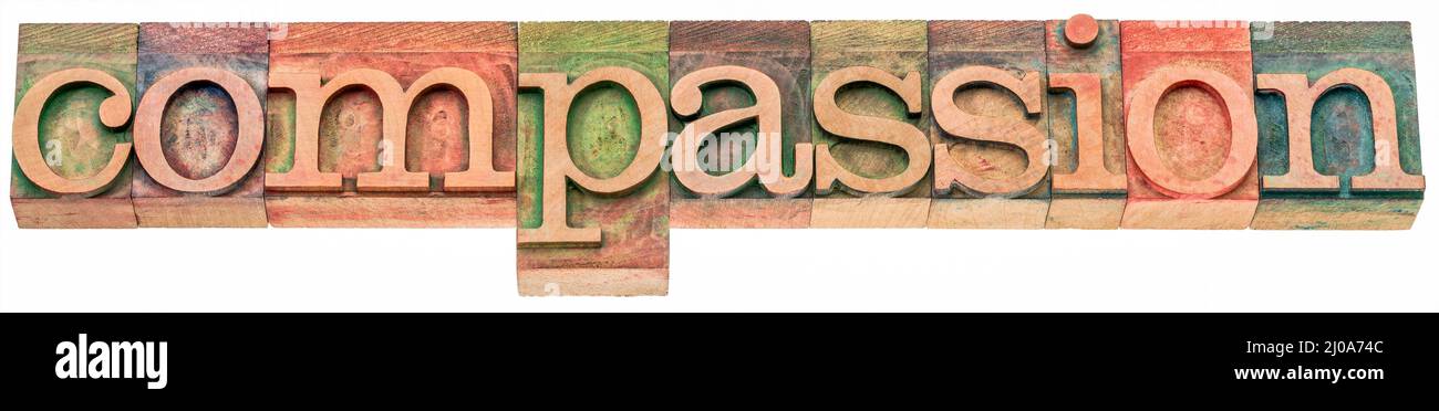compassione - parola isolata astratta nel tipo di legno della pressa della lettera d'annata, pietà simpatica e preoccupazione per le sofferenze o le misfortune degli altri Foto Stock