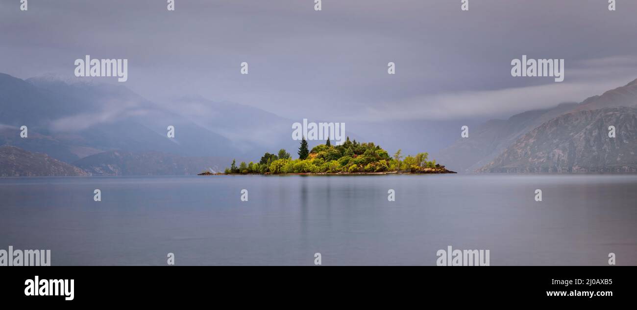 Ruby Island sul lago Wanaka con montagne sullo sfondo nella nebbia, Otago Regione, South Island. Foto Stock