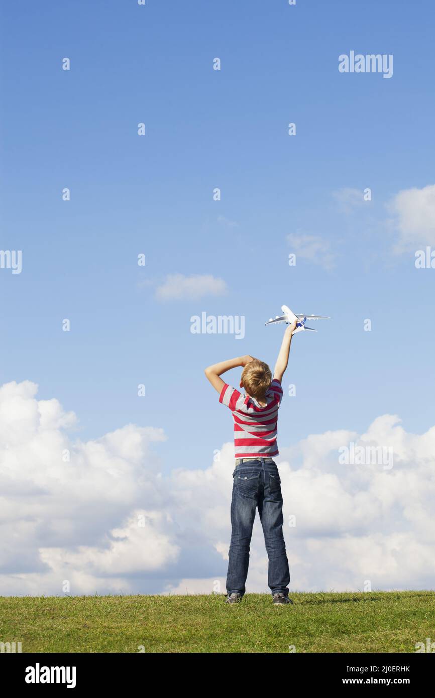 Pre teen caucasico ragazzo tenendo aereo modello Foto Stock