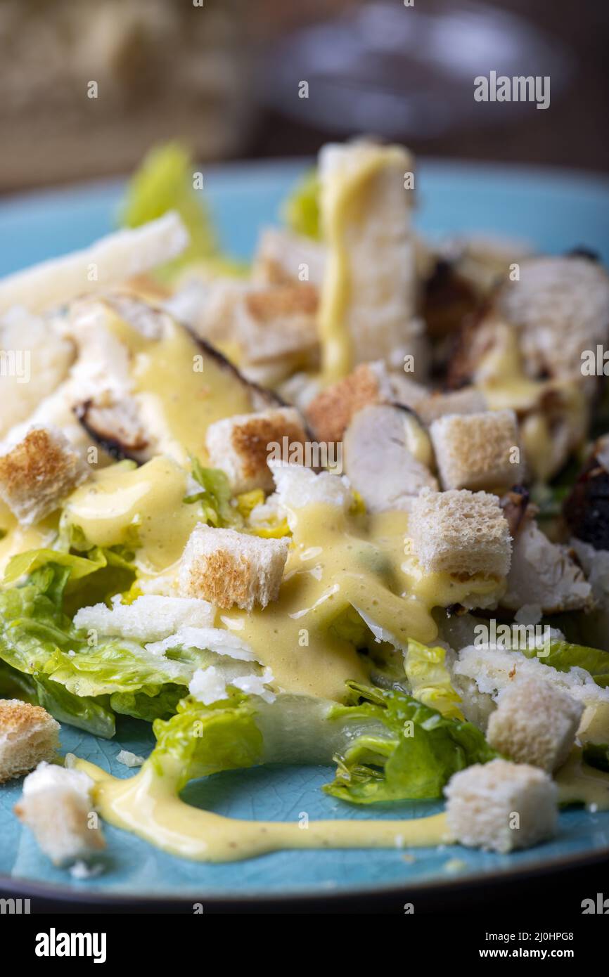 Insalata Caesar su piatto blu Foto Stock