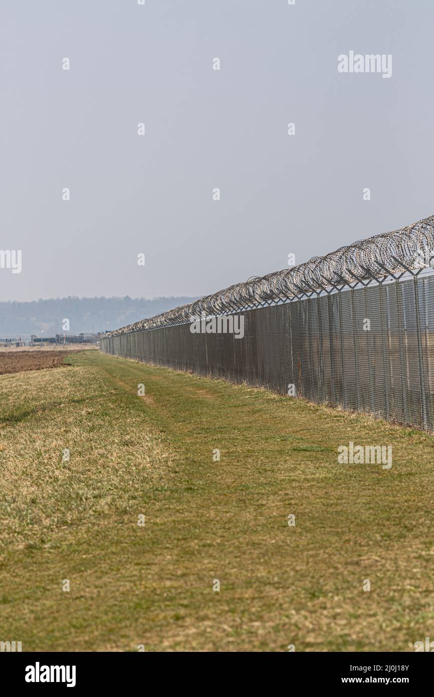 una recinzione di filo spinato per proteggere un bordo Foto Stock
