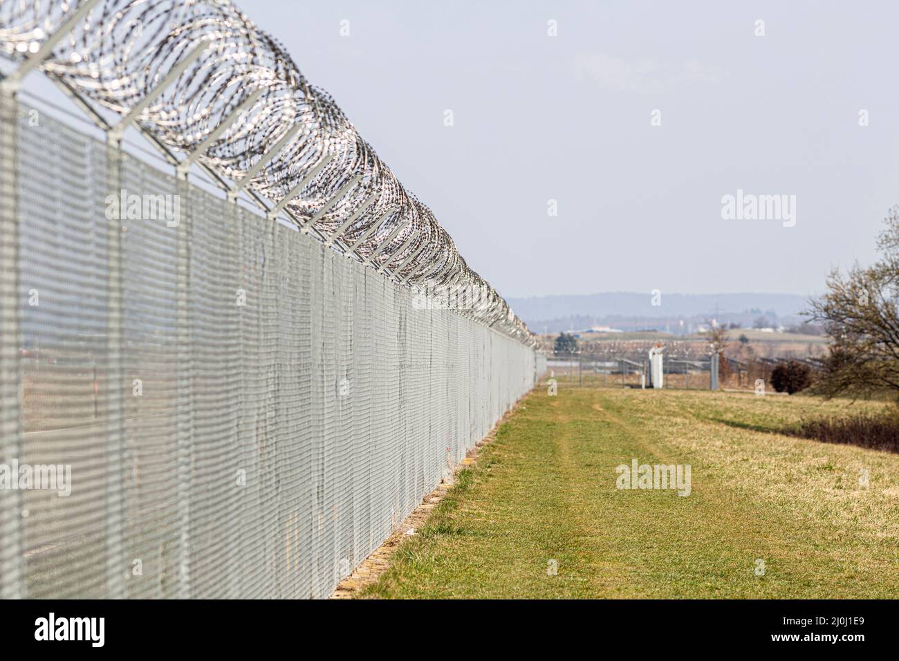 una recinzione di filo spinato per proteggere un bordo Foto Stock