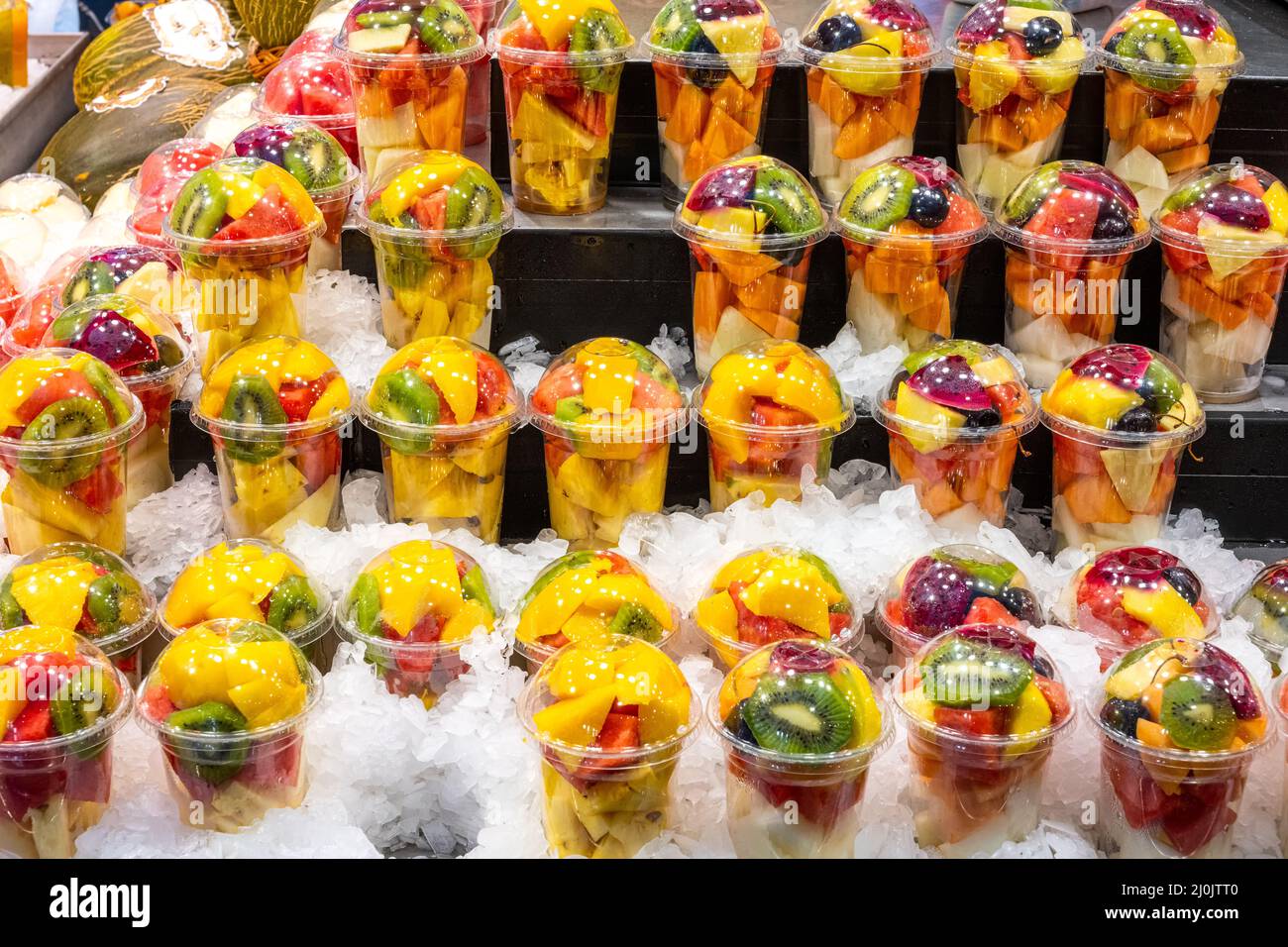 Una varietà di insalate di frutta in un mercato a Barcellona, Spagna Foto Stock