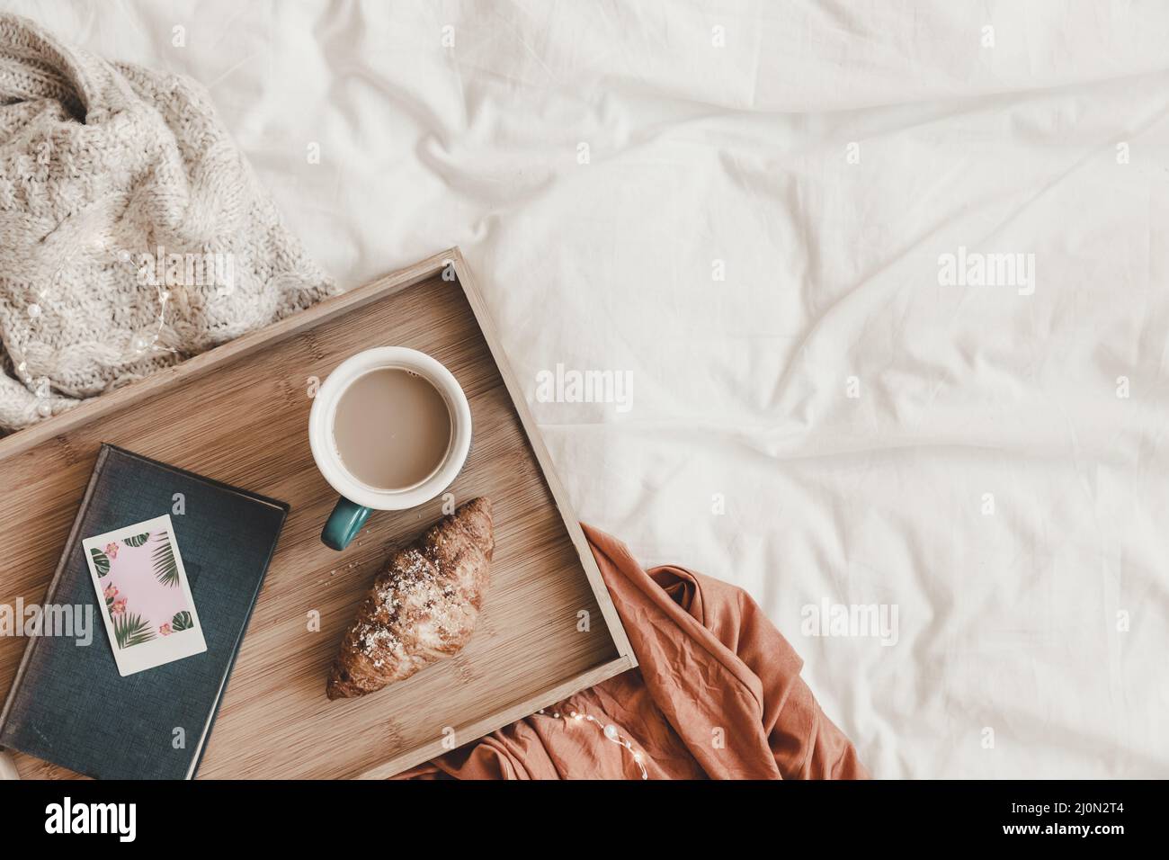 Caffè croissant vicino al letto del libro Foto Stock