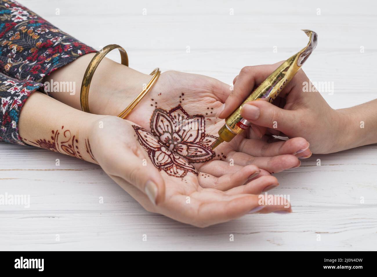 Artista che fa mehndi womans palme Foto Stock