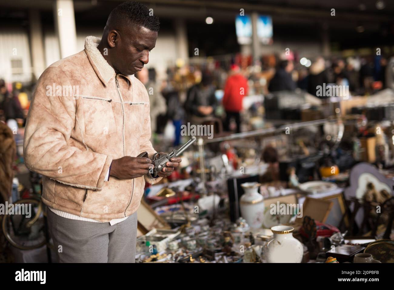 L'uomo afro-americano sceglie l'antiquariato sul mercato delle pulci Foto Stock