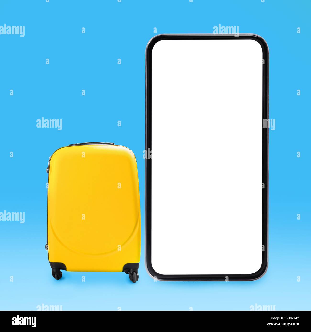 Elegante valigia gialla e grande schermo del telefono cellulare Foto Stock