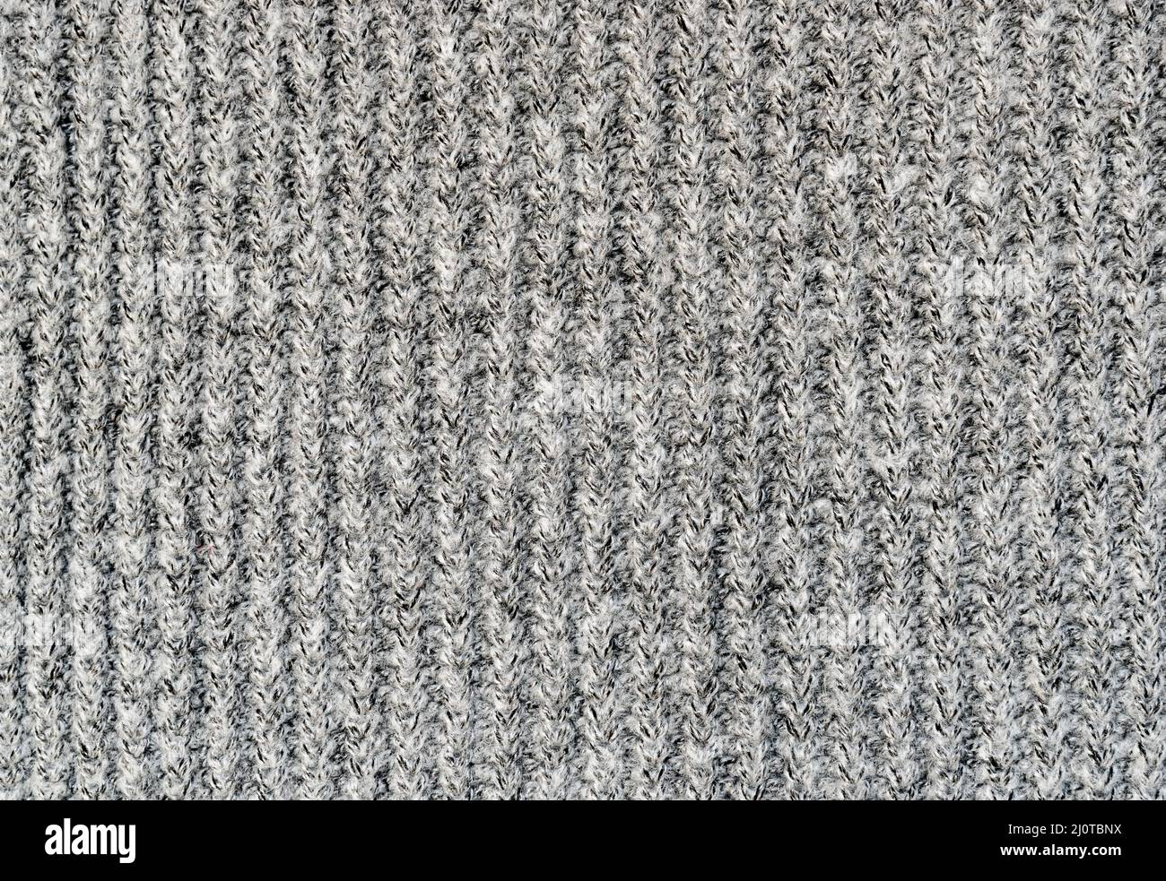 Fondo di tessuto lavorato a mano di lana colore grigio, tessuto lavorato a maglia. Foto Stock