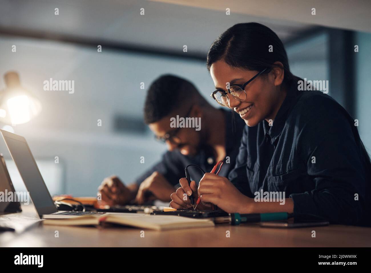 Qualunque sia il momento, ti riporterà online. Shot di due giovani tecnici che riparano insieme l'hardware del computer. Foto Stock