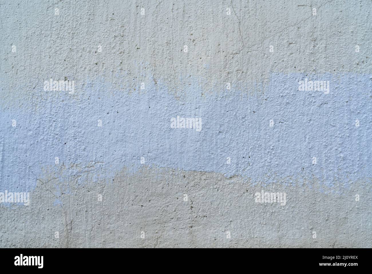 Bianco e beige di vernice sul muro di una casa. Costruzione e riparazione. Foto Stock