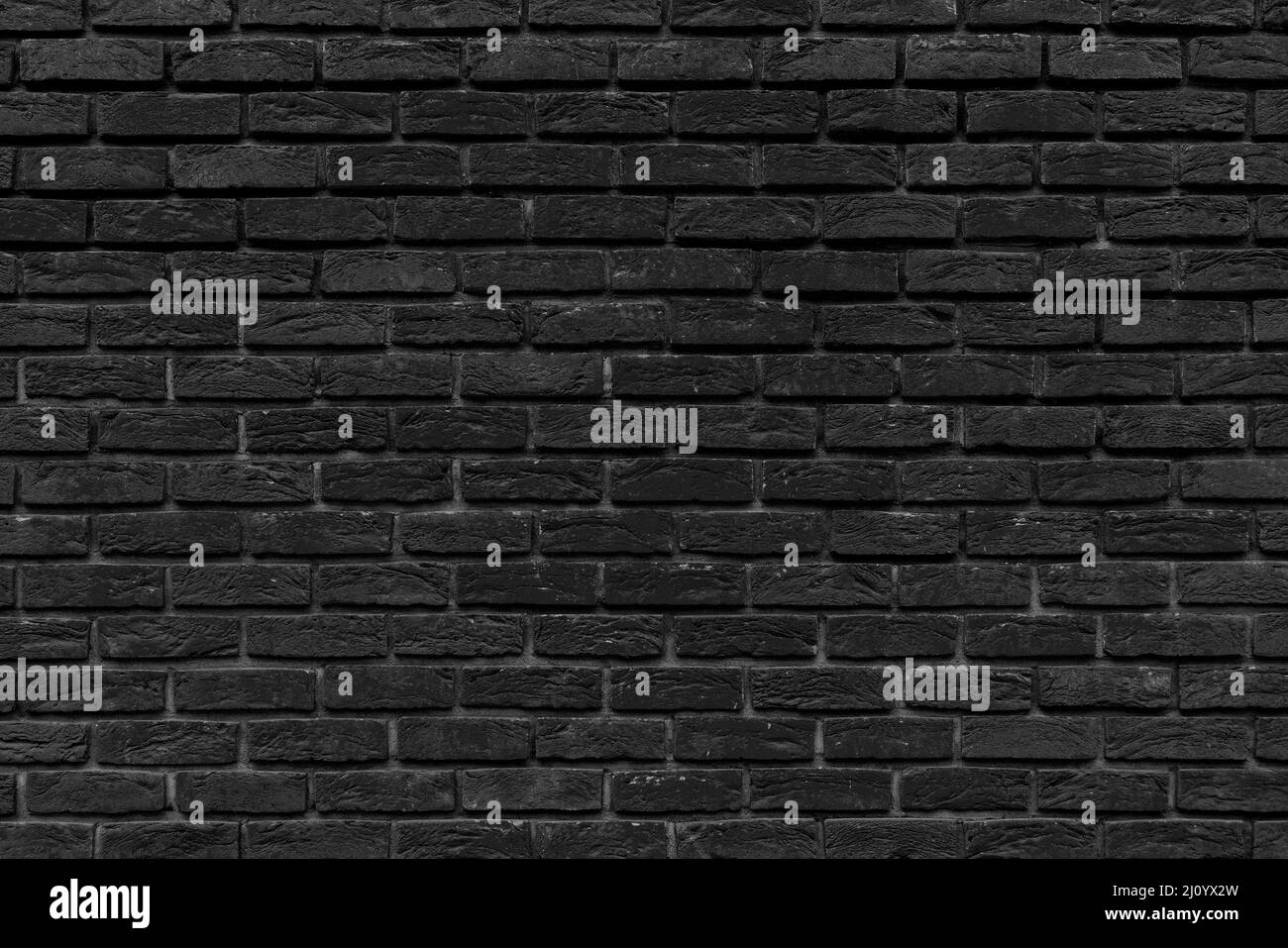 Lo sfondo della vecchia parete nera in mattoni per interni di design Foto Stock