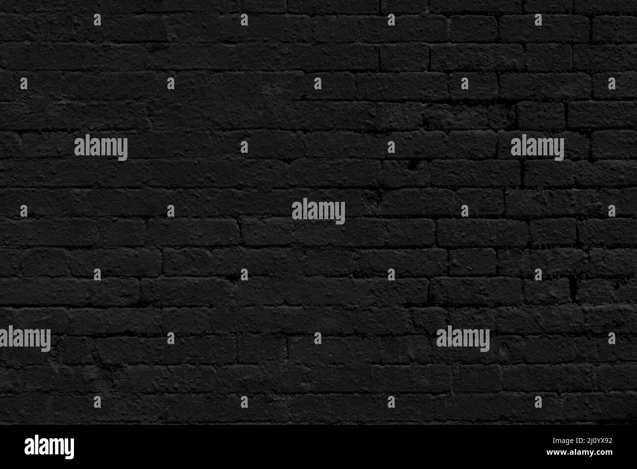Lo sfondo della vecchia parete nera in mattoni per interni di design e varie scene o come sfondo per le interviste video. Foto Stock