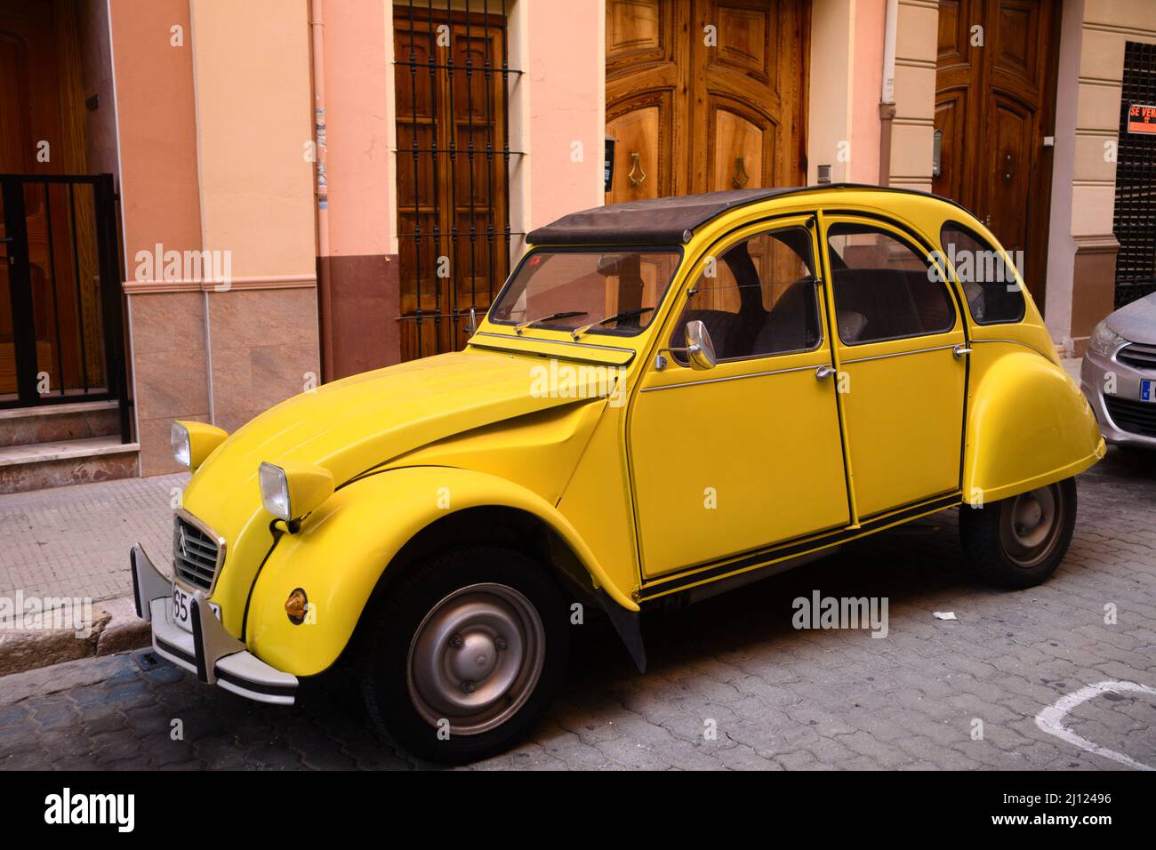 2020. Valencia, Spagna. Auto classica del marchio Citroën, modello 2CV di colore giallo parcheggiato in strada Foto Stock