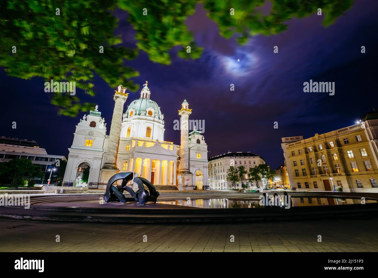 Magica vista serale della Chiesa di San Carlo (Karlskirche). Scena storica, famosa attrazione turistica. Ubicazione Place Karlsplatz a Vienna. Austri Foto Stock