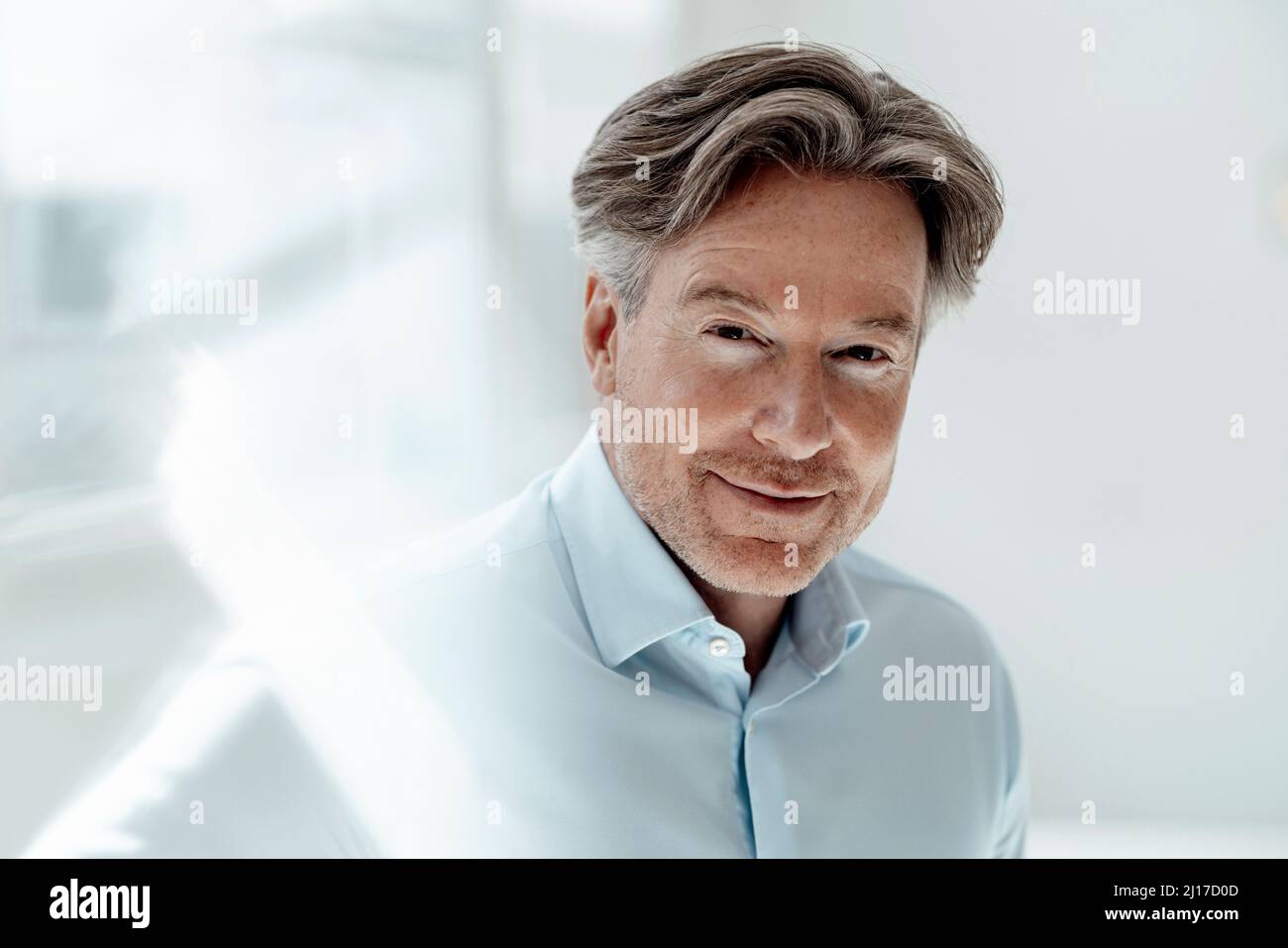 Uomo d'affari che indossa una camicia blu in ufficio Foto Stock