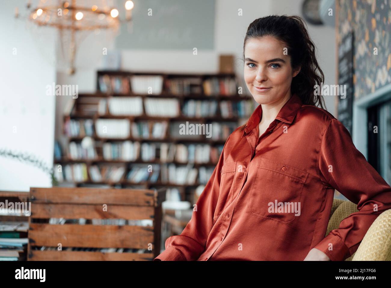 Donna sorridente in seduta cafe Foto Stock
