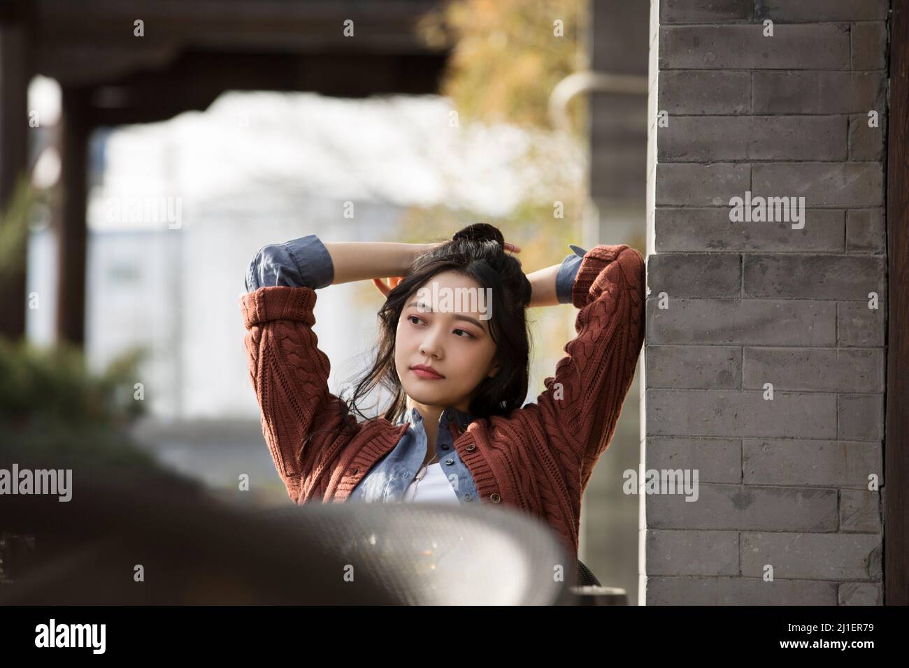 Bella giovane donna cinese che si gode il tè del pomeriggio in caffè marciapiede - foto di scorta Foto Stock
