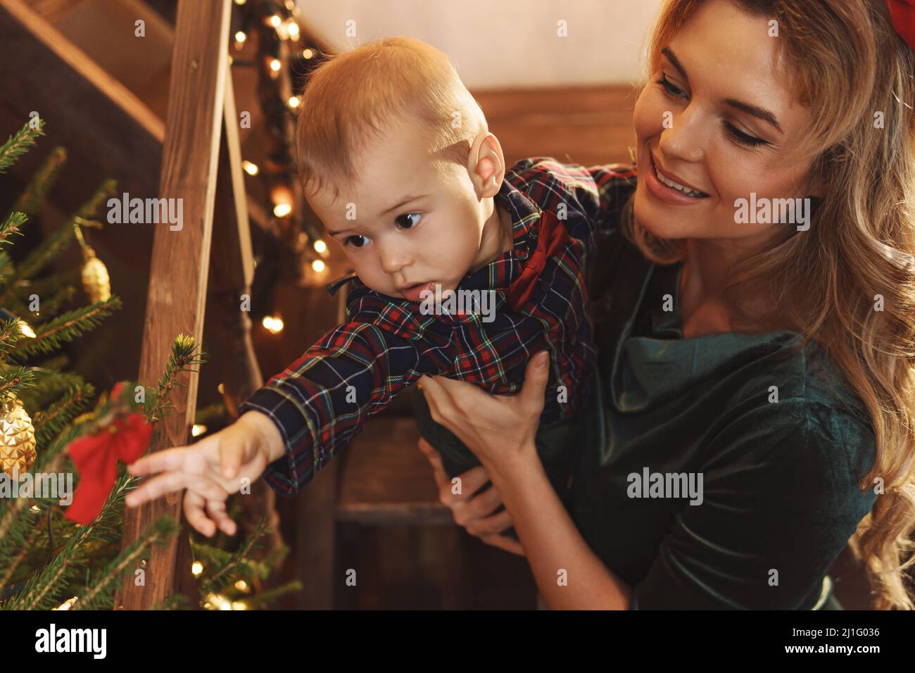 La madre felice ed il suo piccolo figlio carino stanno celebrando il Natale o l'anno nuovo. Foto Stock