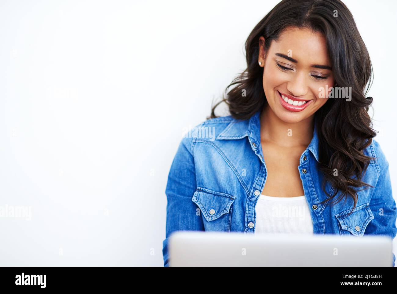 Navigare in rete. Scatto di una giovane donna che naviga sul Web sul suo portatile a casa. Foto Stock
