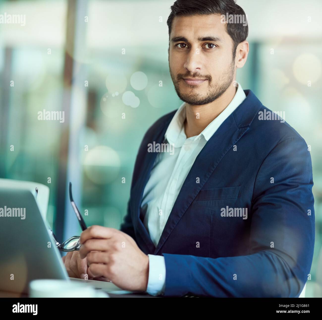 Fiducioso nel suo acumen di affari. Ritratto di un dirigente che lavora su un laptop in un ufficio. Foto Stock