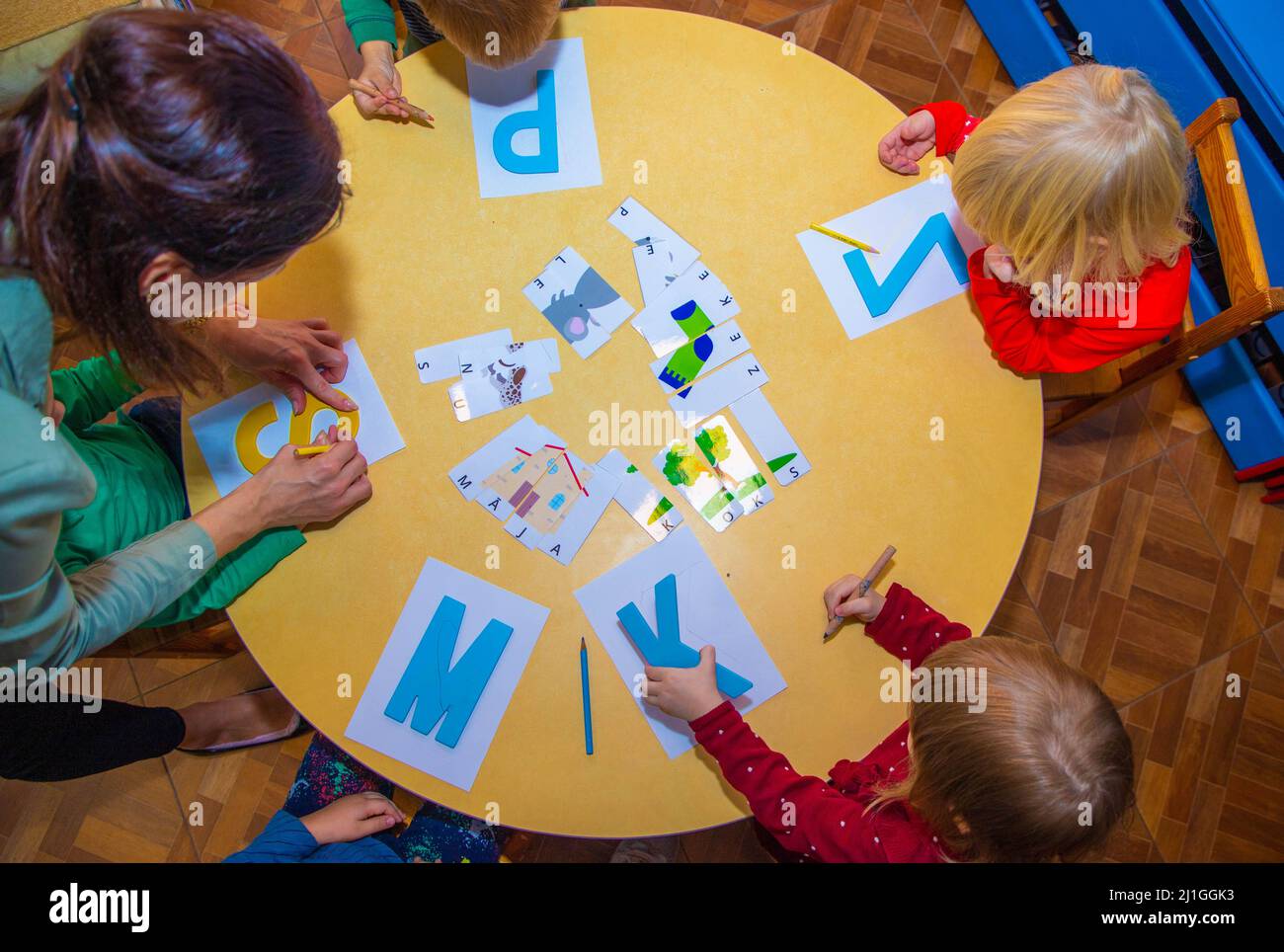 Le mani di un bambino di aspetto europeo cerchiano le lettere inglesi Foto Stock