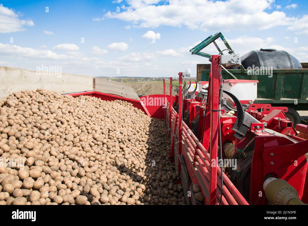 Un trattore che pianta un raccolto di patate sulle praterie Foto Stock