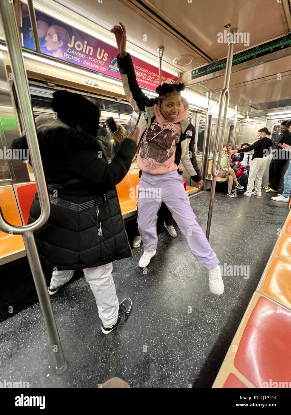 La giovane cantante e ballerina hip-hop si esibisce mentre i suoi amici la registrano mentre si guida un treno 6 lungo Lexington Avenue a Manhattan, New York City. Foto Stock
