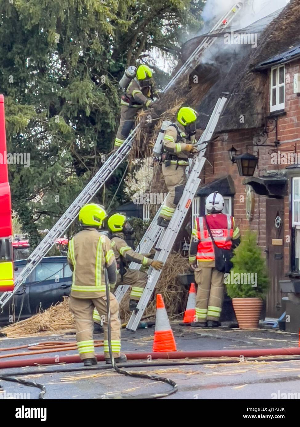 Zafferano Walden, Regno Unito. 27th Mar 2022. Fire oggi distrutto il famoso AX E BUSSOLA pub e ristorante a ARKESDEN, Saffron Walden. Essex. Il pub di paglia del 18th secolo, in essex ha preso il fuoco a mezzogiorno oggi proprio come il Christou si stava preparando per il loro giorno più trafficato dell'anno, con più di 150 prenotazioni per il pranzo del giorno delle madri. Essex vigili del fuoco e ambulanza hanno partecipato. Non sono state segnalate perdite. Molti ospiti abituali del pub all'epoca hanno aiutato a evacuare il personale e i mobili dai locali utilizzando una flotta di carriole. Credit: Mark Bourdillon/Alamy Live News Foto Stock