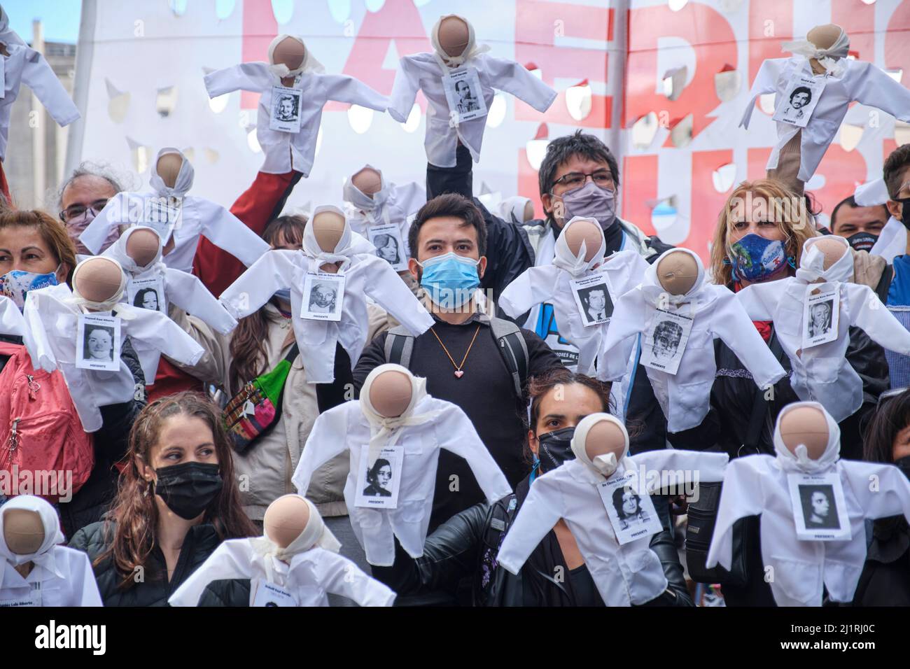 Buenos Aires, Argentina; 24 marzo 2022: Persone in possesso di marionette che rappresentano le madri di Plaza de Mayo, con le loro foulard e poster simbolici bianchi Foto Stock