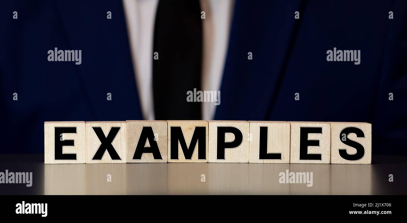 ESEMPI parola scritta su legno blocco. Concetto Foto Stock