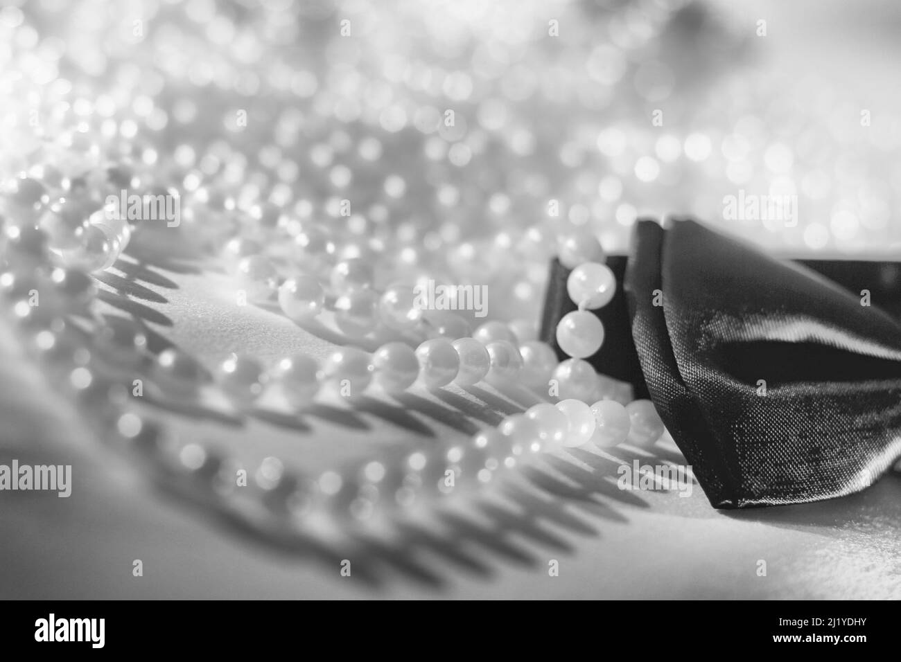 Un primo colpo della lunga collana di perla con un arco in bianco e nero Foto Stock