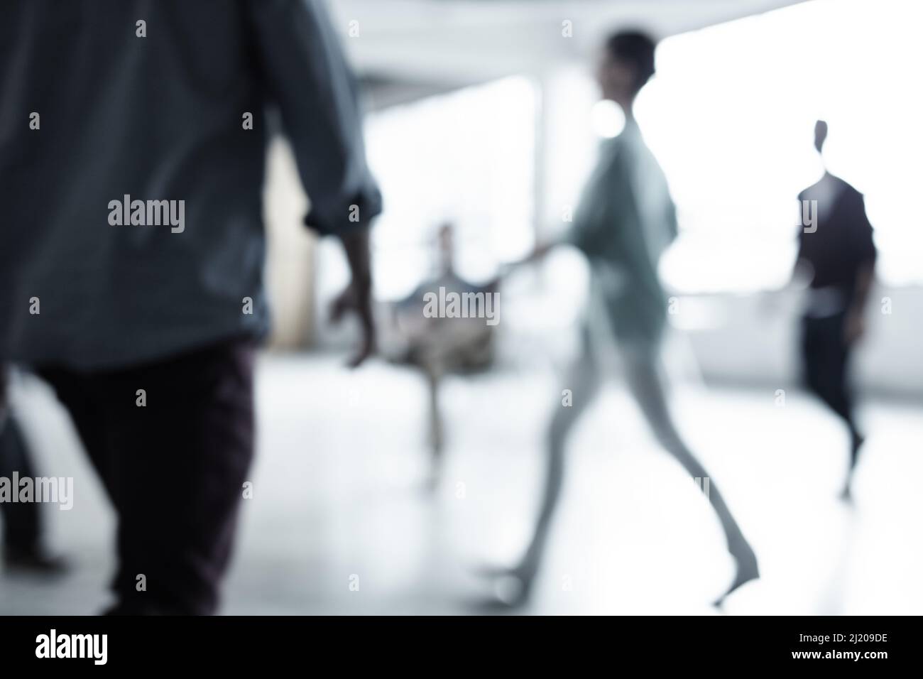 Il mondo aziendale non si ferma mai. Scatto corto di un gruppo di uomini d'affari che camminano attraverso un ufficio. Foto Stock