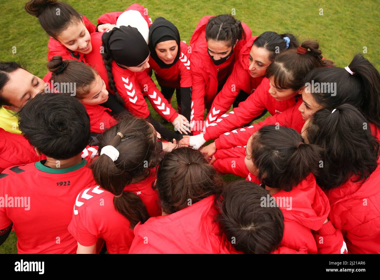 I giocatori della squadra di sviluppo dell'Afghanistan hanno messo le mani insieme prima di iniziare a sfidare la squadra parlamentare delle donne al Dulwich Hamlet Football Club, a sud di Londra. Amnesty International UK sta dando il via al suo Football Welcome Month – un’iniziativa per accogliere rifugiati e persone in cerca di asilo nelle comunità britanniche – organizzando una partita di calcio tra la squadra di sviluppo afghana e la squadra parlamentare femminile. Data foto: Martedì 29 marzo 2022. Foto Stock