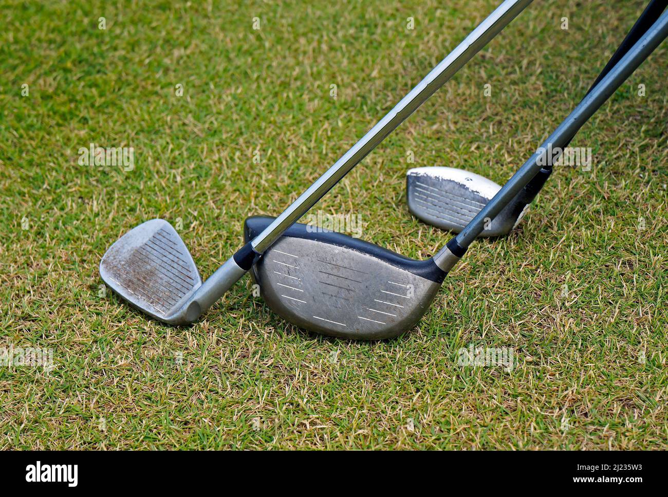 Tre club di golf sull'erba Foto Stock
