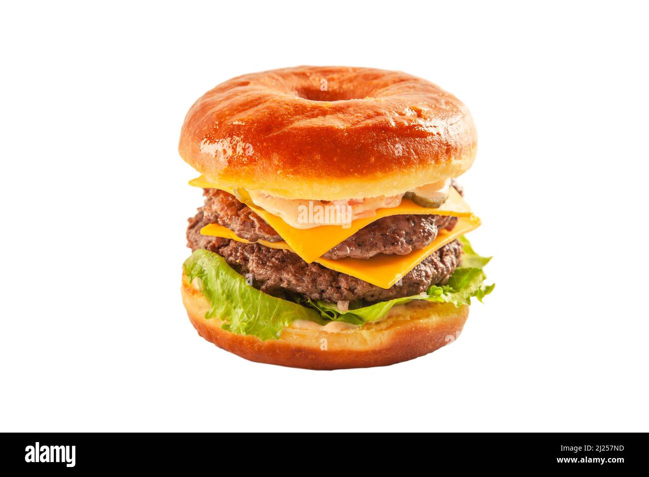 Hamburger con ciambella a due piani con polpettine di manzo e condimento. Foto Stock