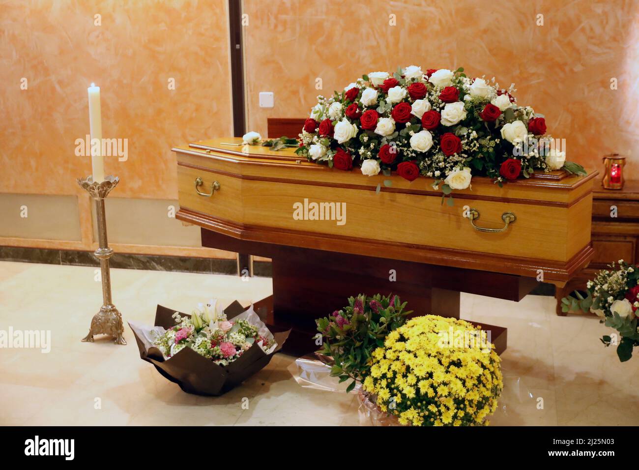 Servizio funerale in una chiesa. Bara con fiori. Foto Stock