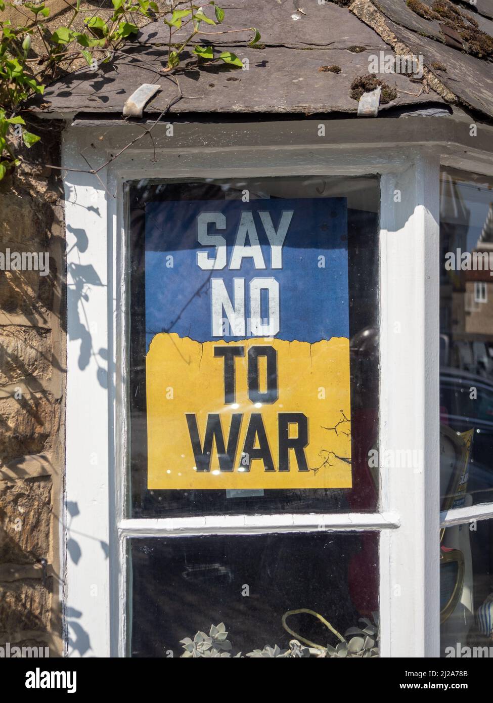 Dire No alla guerra poster sui colori giallo e blu dell'Ucraina, in una finestra, Olney, Buckinghamshire, Regno Unito Foto Stock