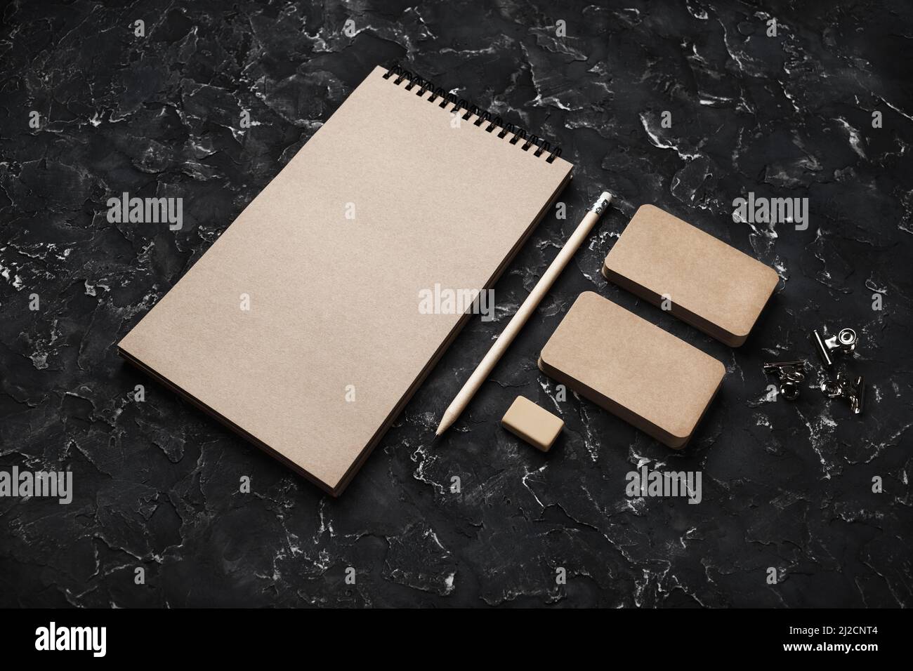 Cancelleria in kraft bianca posta su fondo in gesso nero. Modello di identità aziendale. Mock-up per l'identità di branding per i progettisti. Foto Stock