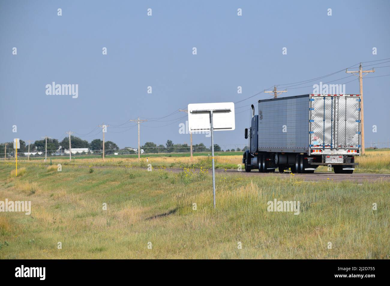 Semi-camion che guida su un'autostrada rurale sulle pianure del Colorado orientale - Agosto 2021 Foto Stock