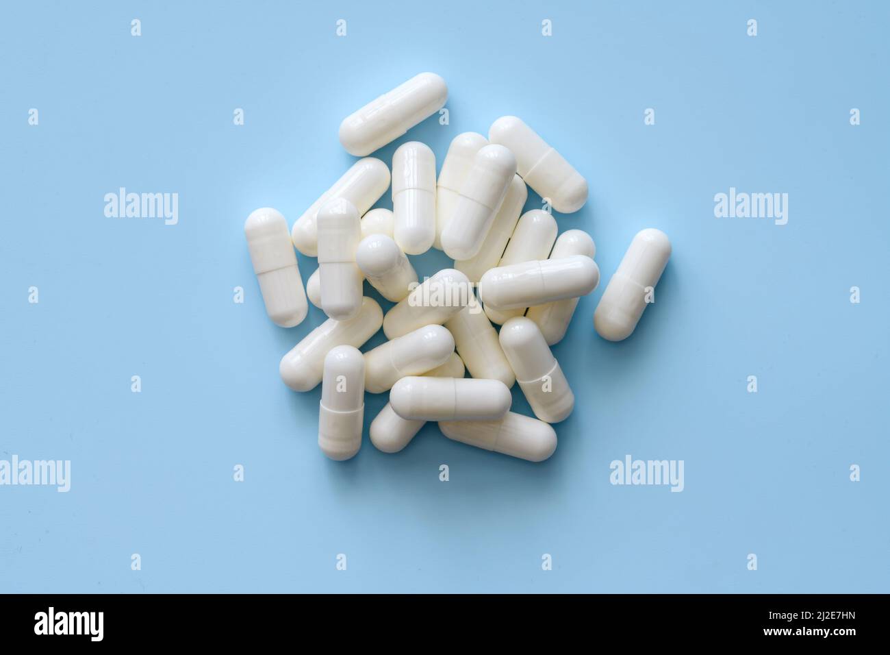Mazzo di pillole bianche su sfondo blu Foto Stock