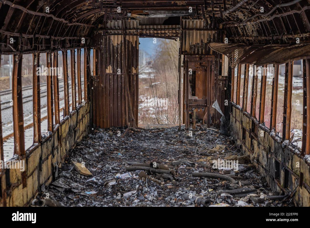 L'interno del vagone o del treno è bruciato. Vecchio vagone ferroviario dopo essere stato messo sul fuoco. Tutto l'interno è bruciato e irriconoscibile. Foto Stock