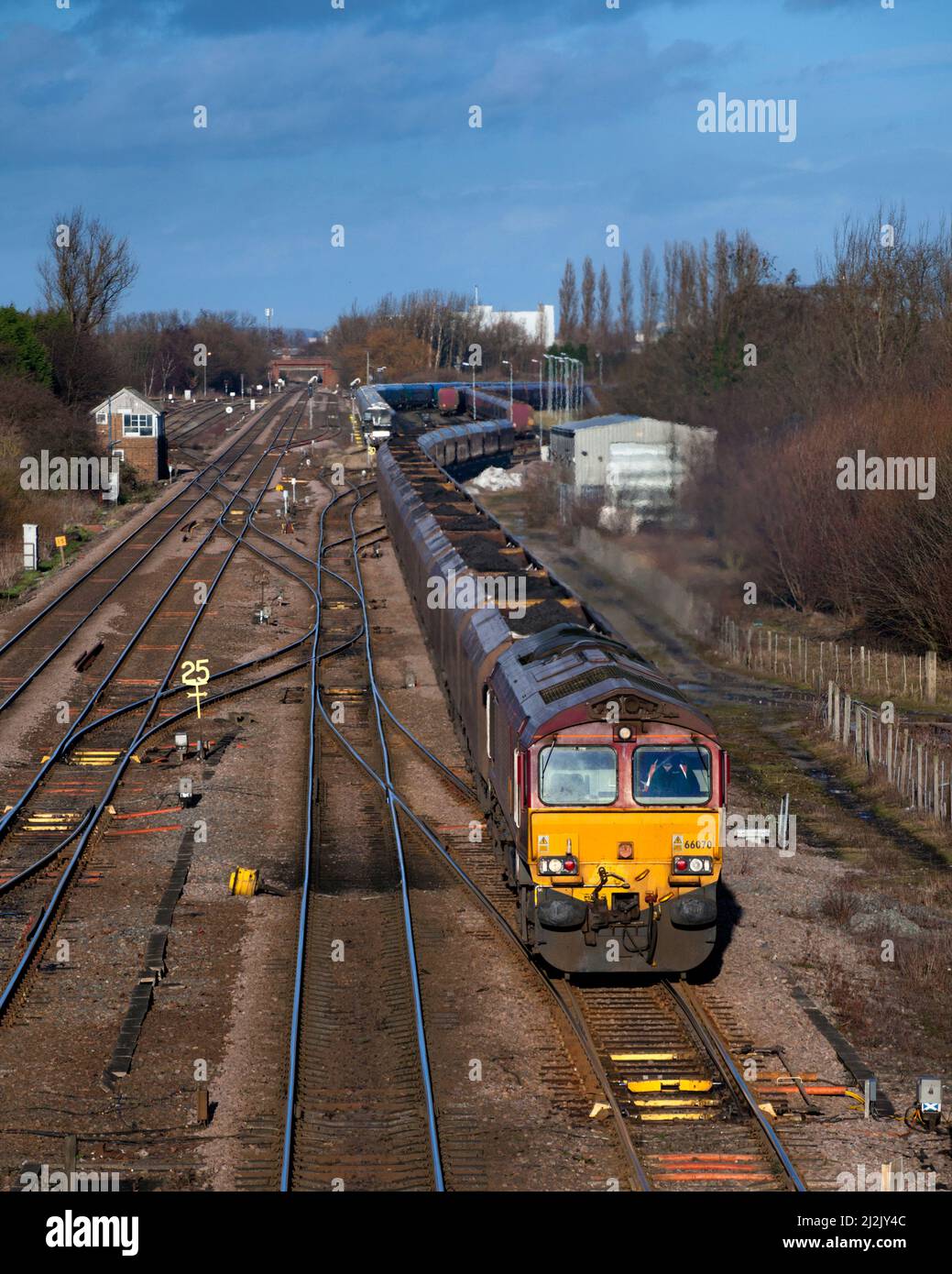 Un DB Cargo classe 66 motrice passando Milford giunzione (ad ovest di Selby) con un Merry Go Round del carbone treno con il carbone importato per Drax power station Foto Stock