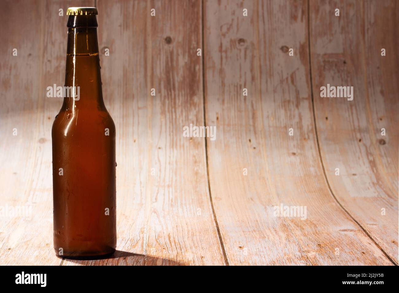bottiglia di birra chiusa su sfondo di legno chiaro Foto Stock