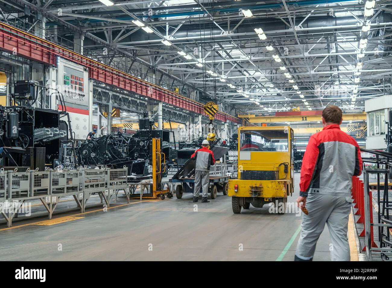 Grande fabbrica industriale. Produzione di macchine agricole. Lavoratori e attrezzature tecniche in officina. Foto Stock