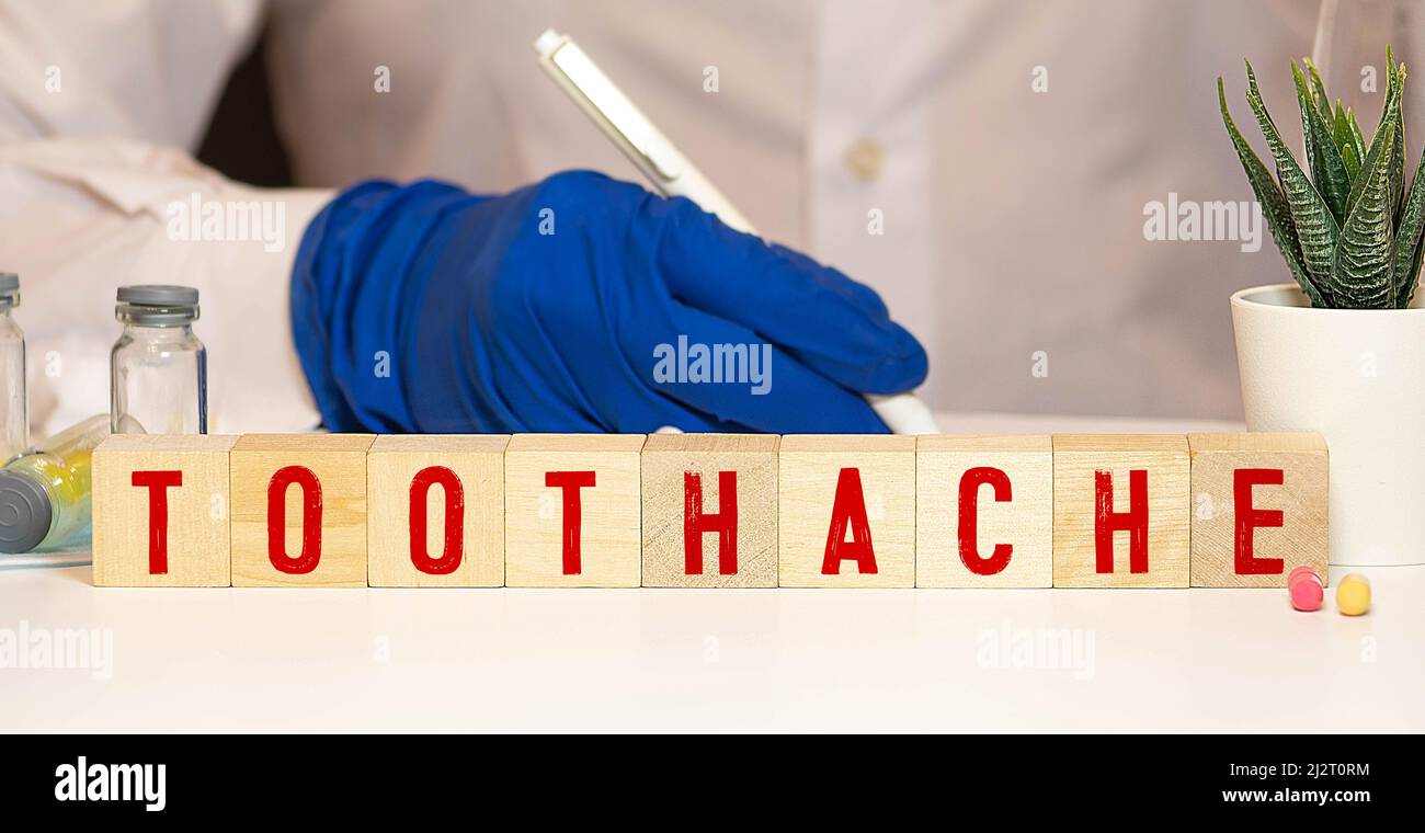 Parola di denticello scritto su blocco di legno, concetto Foto Stock