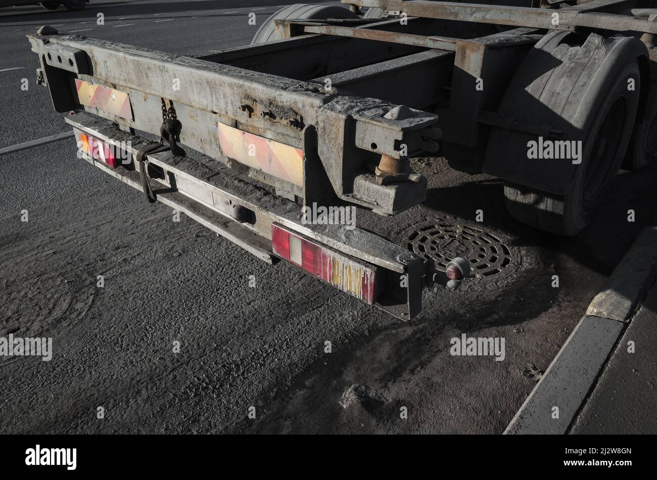 Parte posteriore con luce di posizione posteriore del rimorchio carico autocarro vuoto su strada asfaltata scura Foto Stock