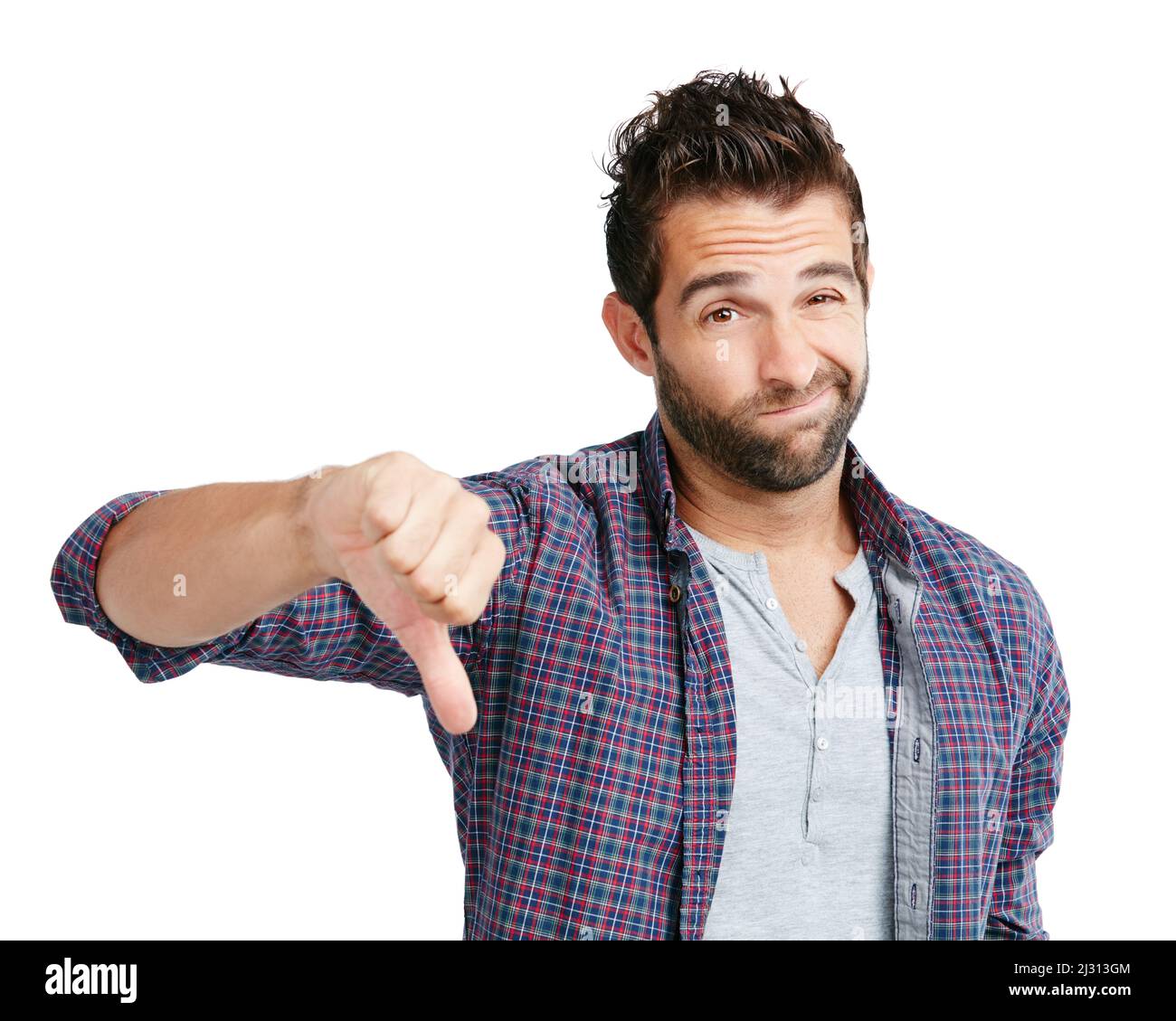 Sì, forse la prossima volta. Studio girato di un giovane uomo mostrando i pollici giù su uno sfondo bianco. Foto Stock