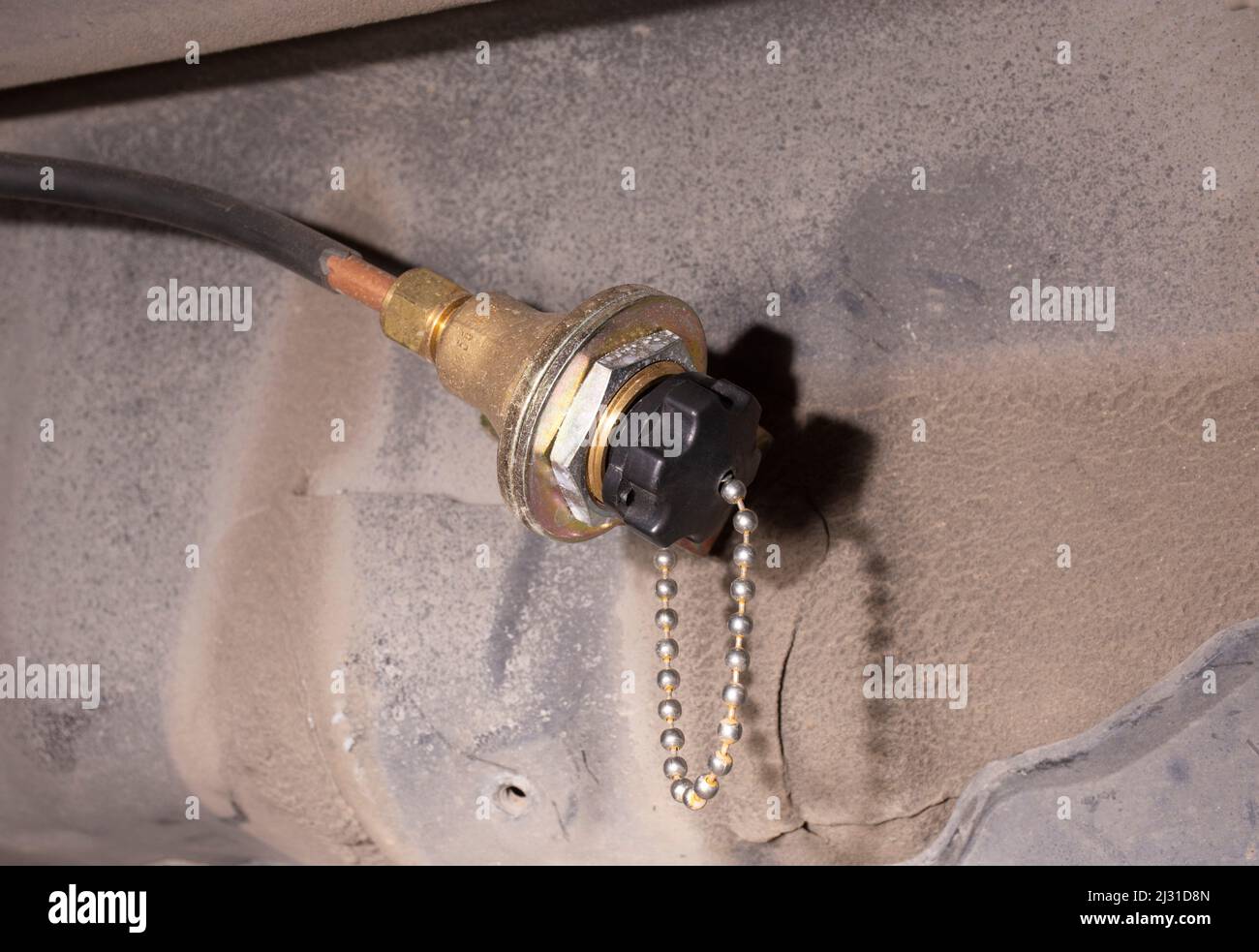 Tubo di riempimento del gas del serbatoio del gas GPL con un coperchio sotto nell'automobile Foto Stock
