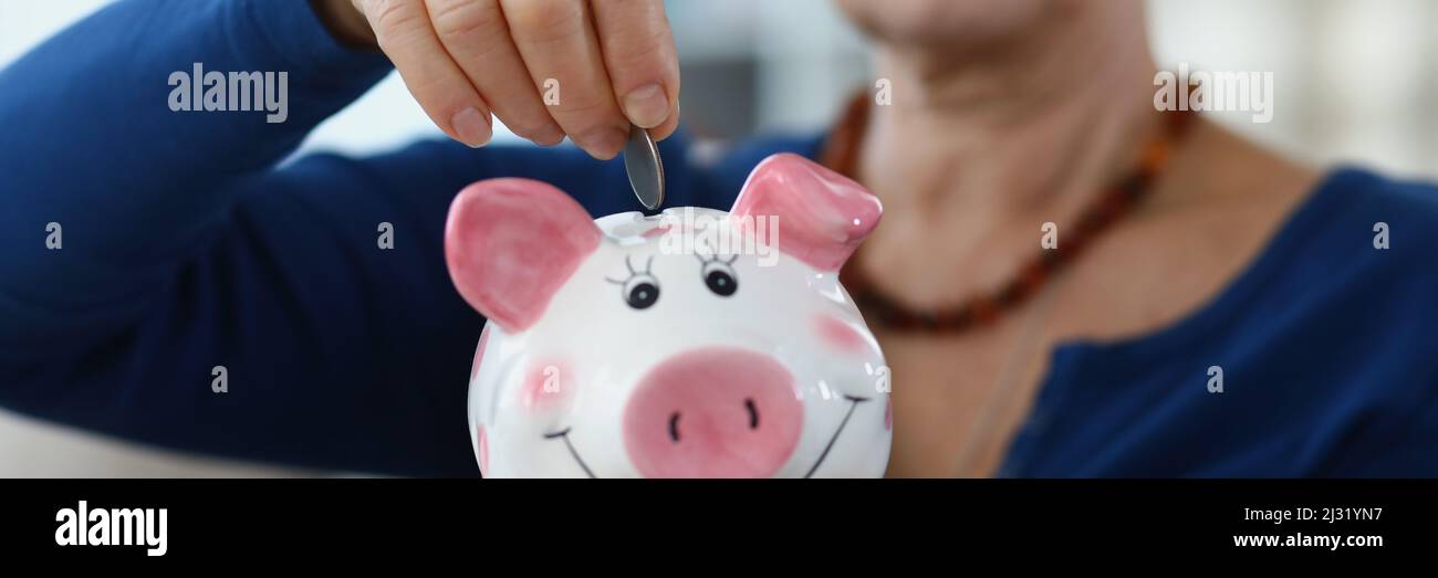 Senior Lady risparmiare reddito in contenitore Foto Stock